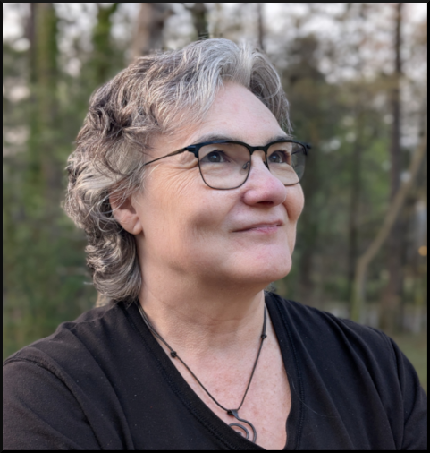 Photo of the author, an older white woman with short gray hair, looking up and smiling.